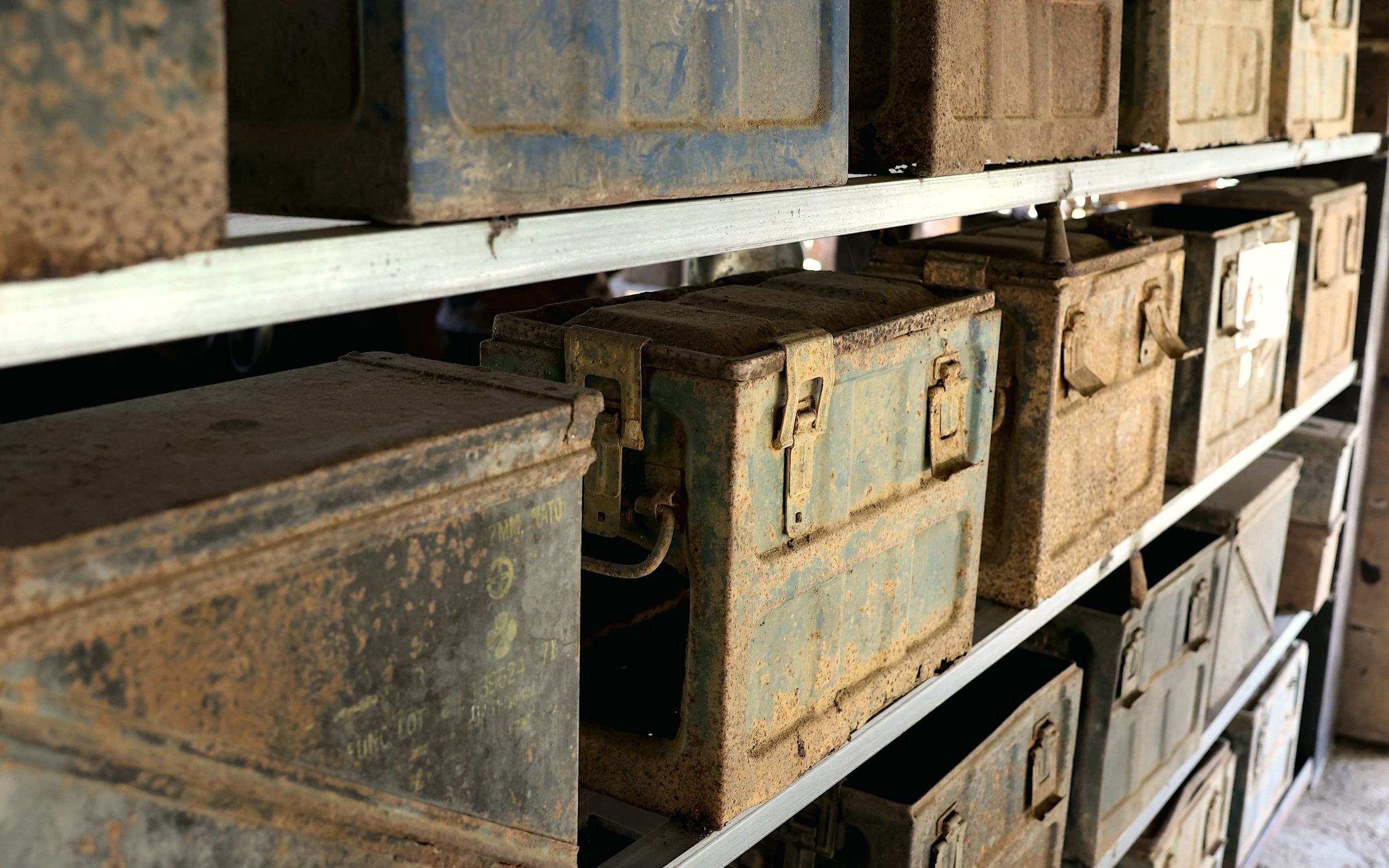 Metal supply boxes stacked on storage shelves